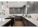 Modern kitchen boasts gray cabinets, quartz countertops, stainless appliances, and herringbone backsplash at 60 Newcastle Sw St, Atlanta, GA 30314