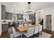 Modern kitchen with island, gray cabinets, and stainless appliances, dining table with seating at 60 Newcastle Sw St, Atlanta, GA 30314