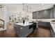 Spacious kitchen with gray cabinets, a kitchen island, and an open layout connecting to the dining and living areas at 60 Newcastle Sw St, Atlanta, GA 30314