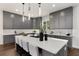 Modern kitchen featuring an island with seating, stylish gray cabinets, and herringbone backsplash at 60 Newcastle Sw St, Atlanta, GA 30314