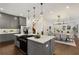 Open-concept kitchen with gray cabinets, a large island, and a seamless transition into the dining and living areas at 60 Newcastle Sw St, Atlanta, GA 30314