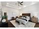 This main bedroom offers a tray ceiling, ceiling fan, sitting area, and a neutral color palette at 60 Newcastle Sw St, Atlanta, GA 30314
