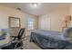 Bedroom with a bed, desk, and window, carpeted floor at 574 Martin Forest Ln, Lawrenceville, GA 30045