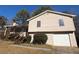 Beige house with brown trim, attached garage, and steps leading to a covered porch at 2656 Del Ridge Dr, Douglasville, GA 30135