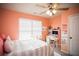 Bedroom with peach walls, a bed, and a built-in workspace at 264 Magnaview Dr, Mcdonough, GA 30253