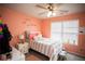 Bedroom with peach walls, a bed, and a ceiling fan at 264 Magnaview Dr, Mcdonough, GA 30253