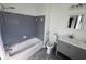 Clean bathroom with gray tile, a tub, and modern vanity at 3251 Oakbrook Ln, Clarkston, GA 30021