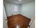 Bright bedroom featuring hardwood floors and large windows at 3251 Oakbrook Ln, Clarkston, GA 30021