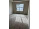 Neutral bedroom with one large window and neutral carpet at 45 Eagle Glen Ne Dr, Cartersville, GA 30121