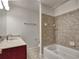 Bathroom with a tiled shower/tub combo, vanity with granite countertop, and updated fixtures at 221 Semel Nw Cir # 273, Atlanta, GA 30309