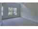 A bedroom bathed in natural light with carpet flooring and neutral wall paint at 221 Semel Nw Cir # 273, Atlanta, GA 30309