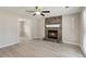 Cozy living room featuring a stone fireplace and modern ceiling fan at 2852 Emerson Lake Dr, Snellville, GA 30078