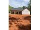 Exterior view of new construction home with covered porch and dark roof ready for siding install at 542 Palm St, Holly Springs, GA 30115