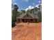 Exterior view of a new home under construction with a dark roof and light wood framing surrounded by trees at 542 Palm St, Holly Springs, GA 30115