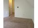 Carpeted bedroom features an angled ceiling and closet space at 333 Pickfair Sw Way, Atlanta, GA 30315