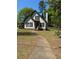 Charming home with a gabled roof, black shutters, and a walkway leading to the front door at 333 Pickfair Sw Way, Atlanta, GA 30315