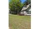 View of the side and back of home with wood deck and green lawn at 333 Pickfair Sw Way, Atlanta, GA 30315