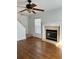 A living room featuring hardwood floors, a traditional fireplace, staircase, and natural light at 333 Pickfair Sw Way, Atlanta, GA 30315
