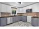 Updated kitchen featuring gray cabinets and marble-look flooring at 2142 Cloverdale Se Dr, Atlanta, GA 30316