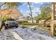 View of backyard featuring a carport with parking area and wooden stairs to an upper level deck at 1770 South Olympian Sw Way, Atlanta, GA 30310