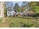 Spacious backyard featuring a detached garage, carport with SUV, and an upper level deck at 1770 South Olympian Sw Way, Atlanta, GA 30310
