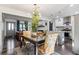 Bright dining area with modern lighting fixture, open to the kitchen and living spaces at 1770 South Olympian Sw Way, Atlanta, GA 30310