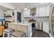 Modern kitchen featuring an island, stainless steel appliances, and stylish lighting at 1770 South Olympian Sw Way, Atlanta, GA 30310