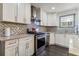 Well-appointed kitchen featuring stainless steel appliances and decorative tile backsplash at 1770 South Olympian Sw Way, Atlanta, GA 30310