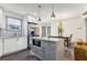Bright, modern kitchen with island, stainless steel appliances, and open layout to dining area at 1770 South Olympian Sw Way, Atlanta, GA 30310