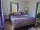 Serene main bedroom featuring plush bedding, hardwood floors, and a view of an ensuite bathroom at 1770 South Olympian Sw Way, Atlanta, GA 30310