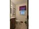 Bathroom features vanity with sink and toilet, plus a window for natural light at 9031 Par Dr, Douglasville, GA 30134