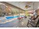 Inviting patio with a covered ceiling, outdoor seating, ceiling fan, and a view of the refreshing inground pool at 9031 Par Dr, Douglasville, GA 30134