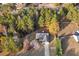 An aerial view of a charming home nestled among mature trees on a private lot at 90 Loudoun Dr, Covington, GA 30014