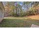 A spacious backyard with a lush lawn and mature trees, perfect for outdoor activities at 90 Loudoun Dr, Covington, GA 30014