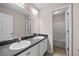 Bathroom featuring a double vanity with dark countertops, undermount sinks and a large mirror at 90 Loudoun Dr, Covington, GA 30014