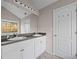 Well-lit bathroom with double vanity sinks, ample counter space, and linen storage at 90 Loudoun Dr, Covington, GA 30014
