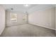 Bedroom with neutral walls, carpeted floors, and windows providing natural light at 90 Loudoun Dr, Covington, GA 30014