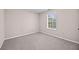 Cozy bedroom featuring carpet floors and a window for natural light at 90 Loudoun Dr, Covington, GA 30014