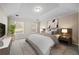 Comfortable main bedroom with tray ceiling, carpet, and an elegant ensuite bath at 90 Loudoun Dr, Covington, GA 30014