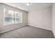Bedroom featuring a window with blinds, carpet floors, and neutral wall color at 90 Loudoun Dr, Covington, GA 30014