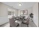 Formal dining room with wainscoting, ample lighting, and a view of the outdoors at 90 Loudoun Dr, Covington, GA 30014