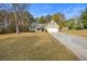 House exterior showcasing a tan colored home with a driveway at 90 Loudoun Dr, Covington, GA 30014