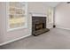 Close-up of the fireplace in the living room with surrounding windows at 90 Loudoun Dr, Covington, GA 30014