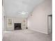 Spacious living room with a fireplace and two windows offering a well-lit space at 90 Loudoun Dr, Covington, GA 30014