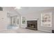 Bright living room with a stone fireplace and large windows for natural light at 90 Loudoun Dr, Covington, GA 30014