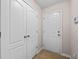 Mud room with tile flooring, storage closet, and exterior door at 90 Loudoun Dr, Covington, GA 30014