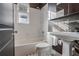 Bright bathroom featuring a tub, toilet, and sink, enhanced by subway tile and decorative flooring at 908 Juniper Ne St # 205, Atlanta, GA 30309