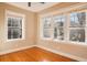 Cozy bedroom showcasing beautiful hardwood floors and multiple windows for abundant natural light at 908 Juniper Ne St # 205, Atlanta, GA 30309