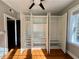 Bedroom with a unique open closet showcasing ample storage space and natural light from a nearby window at 908 Juniper Ne St # 205, Atlanta, GA 30309