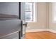 Inviting bedroom entrance with warm hardwood floors and ample natural light streaming through the window at 908 Juniper Ne St # 205, Atlanta, GA 30309